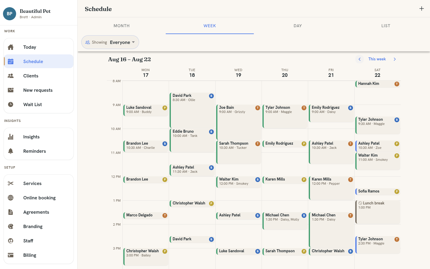 WagBooking Schedule Week view showing a full week of appointments across Monday through Saturday, with colored blocks per client, staff initials, and pet names visible on each booking